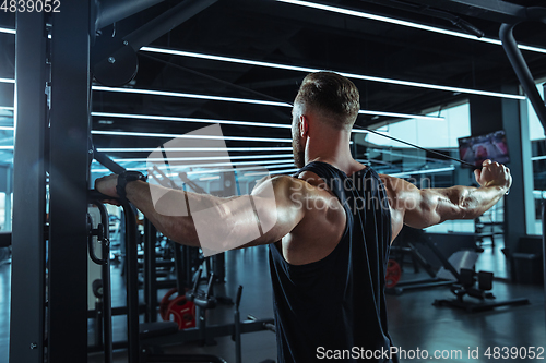 Image of The male athlete training hard in the gym. Fitness and healthy life concept.