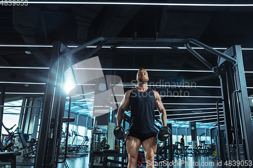 Image of The male athlete training hard in the gym. Fitness and healthy life concept.