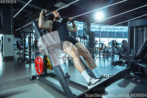 Image of The male athlete training hard in the gym. Fitness and healthy life concept.