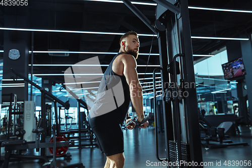 Image of The male athlete training hard in the gym. Fitness and healthy life concept.