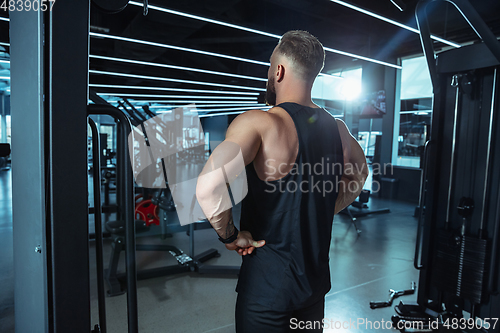 Image of The male athlete training hard in the gym. Fitness and healthy life concept.