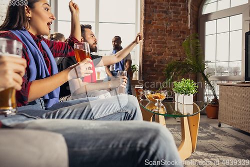 Image of Excited group of people watching football, sport match at home