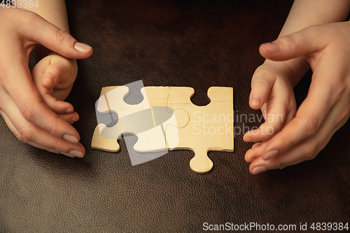 Image of Close up of female and kid\'s hands doing things together, family, home concept