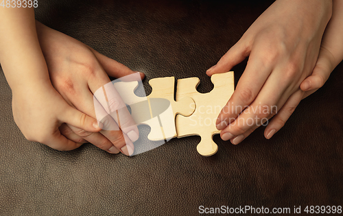 Image of Close up of female and kid\'s hands doing things together, family, home concept