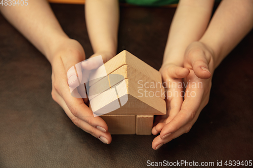 Image of Close up of female and kid\'s hands doing things together, family, home concept
