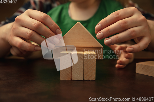 Image of Close up of female and kid\'s hands doing things together, family, home concept