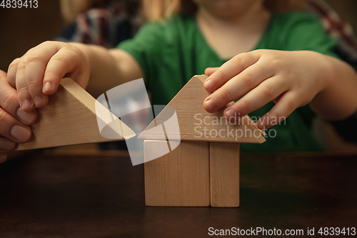 Image of Close up of female and kid\'s hands doing things together, family, home concept