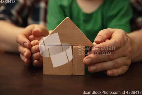Image of Close up of female and kid\'s hands doing things together, family, home concept
