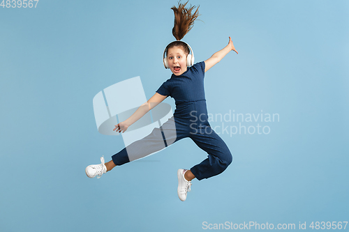 Image of Pretty caucasian girl portrait isolated on blue studio background with copyspace