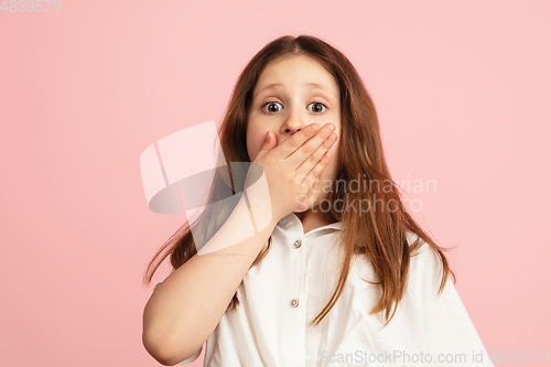 Image of Pretty caucasian girl portrait isolated on pink studio background with copyspace