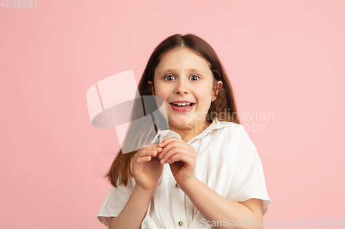 Image of Pretty caucasian girl portrait isolated on pink studio background with copyspace