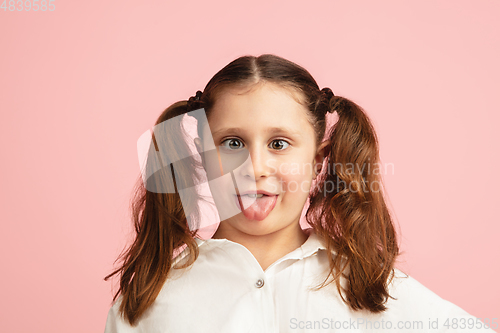 Image of Pretty caucasian girl portrait isolated on pink studio background with copyspace