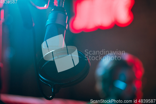 Image of Close-up of musician performing in neon light. Concept of advertising, hobby, music, festival, entertainment.