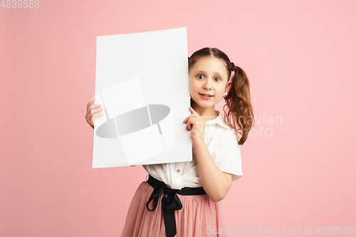 Image of Pretty caucasian girl portrait isolated on pink studio background with copyspace