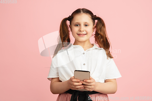 Image of Pretty caucasian girl portrait isolated on pink studio background with copyspace