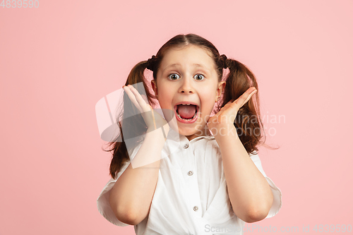 Image of Pretty caucasian girl portrait isolated on pink studio background with copyspace