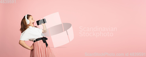 Image of Pretty caucasian girl portrait isolated on pink studio background with copyspace