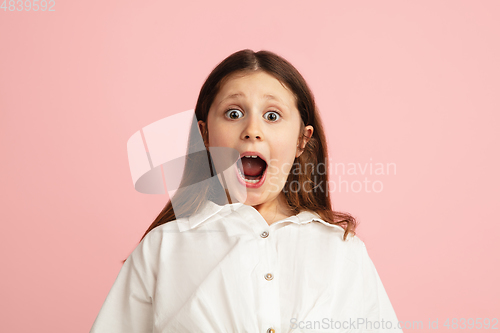 Image of Pretty caucasian girl portrait isolated on pink studio background with copyspace