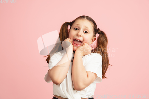 Image of Pretty caucasian girl portrait isolated on pink studio background with copyspace