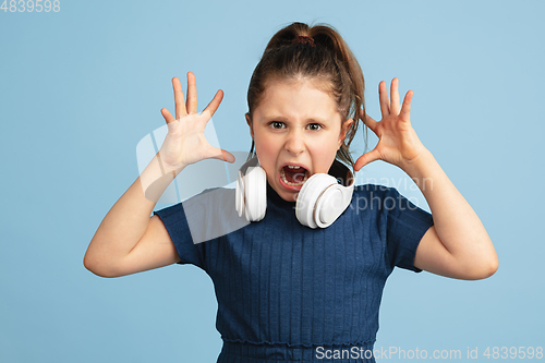 Image of Pretty caucasian girl portrait isolated on blue studio background with copyspace