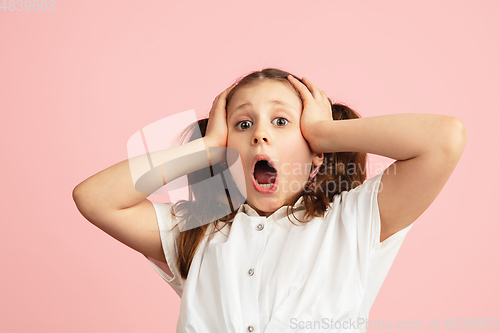 Image of Pretty caucasian girl portrait isolated on pink studio background with copyspace