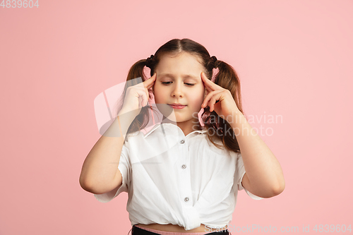 Image of Pretty caucasian girl portrait isolated on pink studio background with copyspace