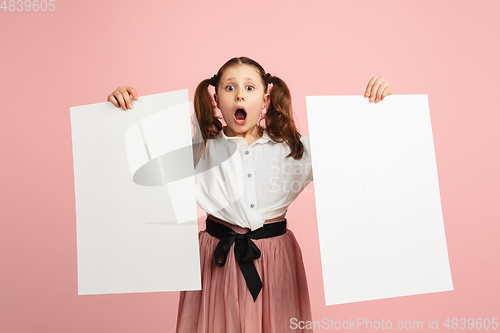 Image of Pretty caucasian girl portrait isolated on pink studio background with copyspace