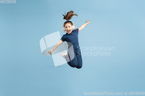 Image of Pretty caucasian girl portrait isolated on blue studio background with copyspace