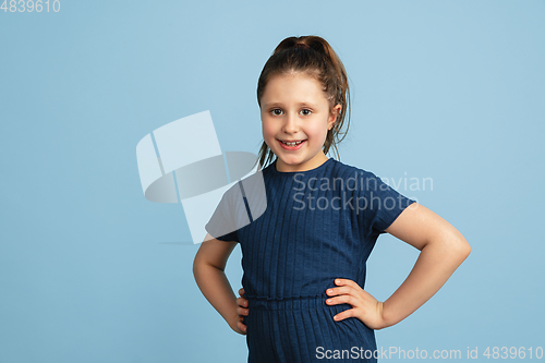 Image of Pretty caucasian girl portrait isolated on blue studio background with copyspace