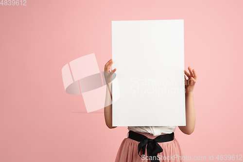 Image of Pretty caucasian girl portrait isolated on pink studio background with copyspace