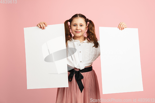 Image of Pretty caucasian girl portrait isolated on pink studio background with copyspace