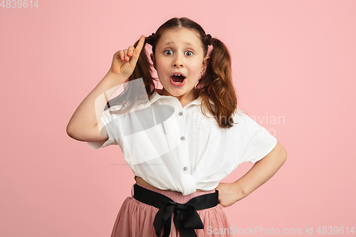 Image of Pretty caucasian girl portrait isolated on pink studio background with copyspace