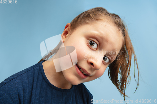 Image of Pretty caucasian girl portrait isolated on blue studio background with copyspace