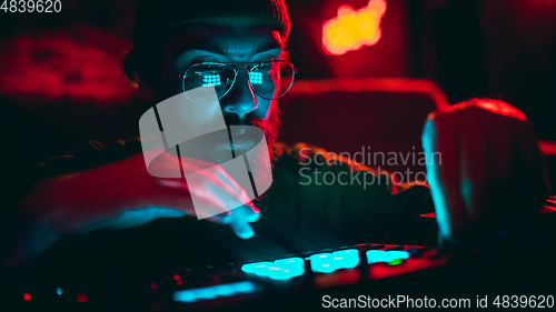 Image of Close-up of musician performing in neon light. Concept of advertising, hobby, music, festival, entertainment.