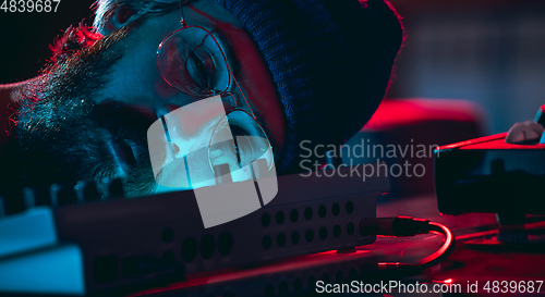 Image of Close-up of musician performing in neon light. Concept of advertising, hobby, music, festival, entertainment.