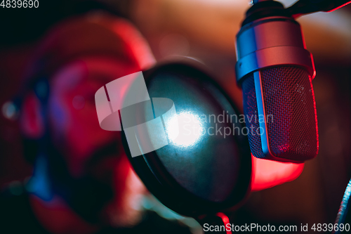 Image of Close-up of musician performing in neon light. Concept of advertising, hobby, music, festival, entertainment.