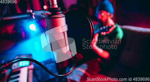 Image of Close-up of musician performing in neon light. Concept of advertising, hobby, music, festival, entertainment.