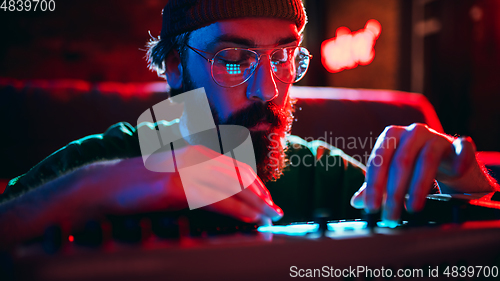 Image of Close-up of musician performing in neon light. Concept of advertising, hobby, music, festival, entertainment.