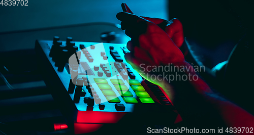 Image of Close-up of musician performing in neon light. Concept of advertising, hobby, music, festival, entertainment.