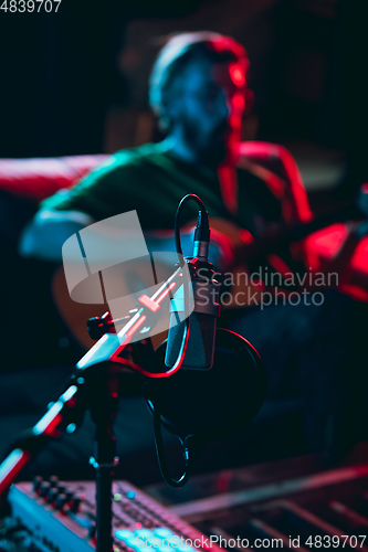 Image of Close-up of musician performing in neon light. Concept of advertising, hobby, music, festival, entertainment.