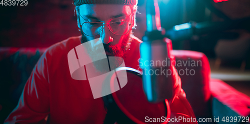 Image of Close-up of musician performing in neon light. Concept of advertising, hobby, music, festival, entertainment.