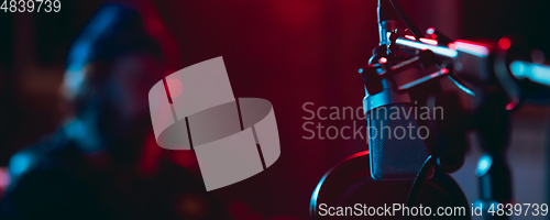 Image of Close-up of musician performing in neon light. Concept of advertising, hobby, music, festival, entertainment.