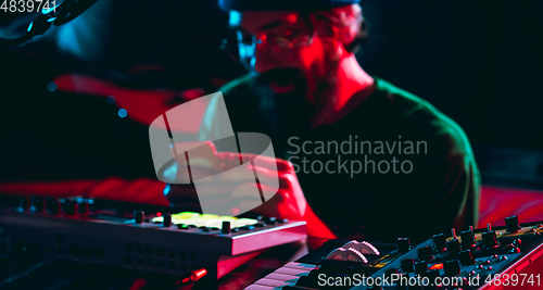 Image of Close-up of musician performing in neon light. Concept of advertising, hobby, music, festival, entertainment.