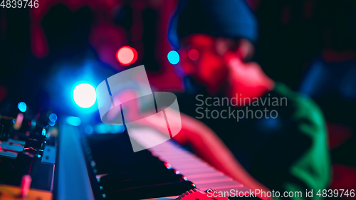 Image of Close-up of musician performing in neon light. Concept of advertising, hobby, music, festival, entertainment.