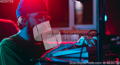 Image of Close-up of musician performing in neon light. Concept of advertising, hobby, music, festival, entertainment.