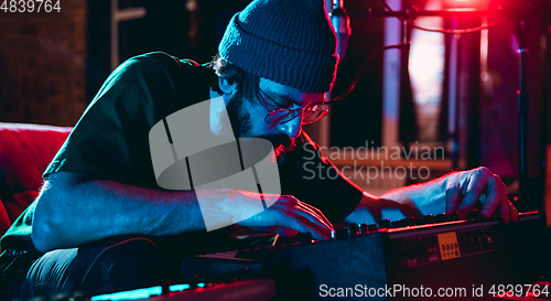 Image of Close-up of musician performing in neon light. Concept of advertising, hobby, music, festival, entertainment.