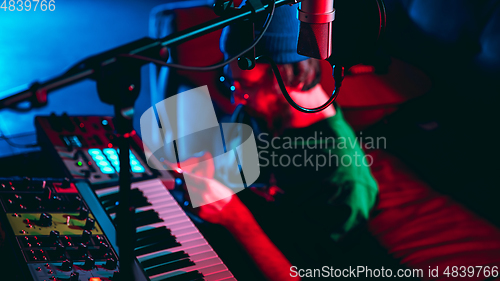 Image of Close-up of musician performing in neon light. Concept of advertising, hobby, music, festival, entertainment.