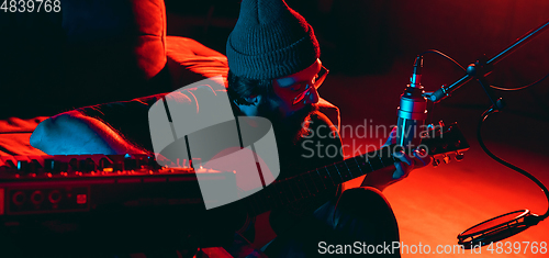 Image of Close-up of musician performing in neon light. Concept of advertising, hobby, music, festival, entertainment.