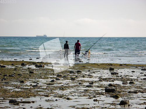 Image of Fishermen on the seashore.