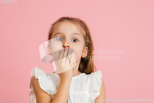 Image of Pretty caucasian girl portrait isolated on pink studio background with copyspace